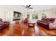 Cozy living room boasts a fireplace, hardwood floors, comfortable seating, and natural light at 552 Odell School Rd, Concord, NC 28027