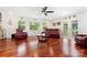 Bright living room features hardwood floors, large windows, comfortable seating, and a ceiling fan at 552 Odell School Rd, Concord, NC 28027
