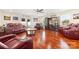 Spacious living room features hardwood floors, plush seating, a ceiling fan, and modern decor at 552 Odell School Rd, Concord, NC 28027