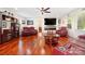 Spacious living room with hardwood floors, cozy seating, and a modern fireplace feature at 552 Odell School Rd, Concord, NC 28027