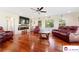 Spacious living room with hardwood floors, a modern fireplace, and comfortable leather sofas at 552 Odell School Rd, Concord, NC 28027