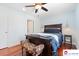 Inviting bedroom featuring a ceiling fan, wooden floors, and a comfortable bed with stylish bench at 552 Odell School Rd, Concord, NC 28027