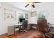 Office space features a wraparound desk, two chairs, hardwood floors, and a window for natural light at 552 Odell School Rd, Concord, NC 28027