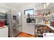 Pantry with stainless steel fridge, and shelving stocked with food and cooking supplies at 552 Odell School Rd, Concord, NC 28027