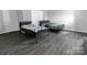 Neutral bedroom featuring two beds, gray floors, white trim and doors, and a double door closet at 6308 Brumit Ln, Charlotte, NC 28269