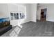 Bright living room featuring modern flooring and large windows allowing plenty of natural light at 6308 Brumit Ln, Charlotte, NC 28269