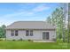 The backyard features an easy to maintain lawn with a small patio at 700 Sunset Pointe Dr, Salisbury, NC 28146