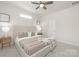 Neutral bedroom offers a large window, a ceiling fan and plush carpet at 700 Sunset Pointe Dr, Salisbury, NC 28146