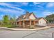 Community clubhouse with a stone fireplace, covered porches, and landscaped grounds at 700 Sunset Pointe Dr, Salisbury, NC 28146