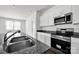 Beautiful kitchen showcasing stone countertops, stainless appliances, and a double basin sink at 700 Sunset Pointe Dr, Salisbury, NC 28146