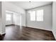 Inviting living room with hardwood floors, large windows, and modern light fixture at 700 Sunset Pointe Dr, Salisbury, NC 28146