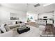Open-concept living space flows to the kitchen with breakfast bar, perfect for entertaining and modern living at 700 Sunset Pointe Dr, Salisbury, NC 28146