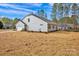 Side-rear view of home with a two-car garage, a lawn area, and a well-maintained yard at 700 Sunset Pointe Dr, Salisbury, NC 28146