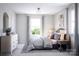 Comfortable bedroom with a large window, stylish decor, and dresser at 7027 Short Stirrup Ln, Mint Hill, NC 28227
