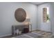 Inviting entryway with decorative table, round wall decor, and a view of the outdoors at 7027 Short Stirrup Ln, Mint Hill, NC 28227