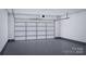 A spacious garage is equipped with a modern door and smooth concrete flooring at 7027 Short Stirrup Ln, Mint Hill, NC 28227
