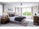 Serene main bedroom with a tufted headboard, bedside tables, and soft lighting at 7027 Short Stirrup Ln, Mint Hill, NC 28227