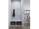 Functional mud room with built-in bench, storage cubbies, and coat hooks at 7027 Short Stirrup Ln, Mint Hill, NC 28227