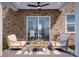Cozy brick patio featuring comfortable seating and a view of the dining area at 7027 Short Stirrup Ln, Mint Hill, NC 28227
