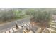 New townhome construction featuring attached garages and community street views, with wooded area at 7918 Nelson Rd, Mint Hill, NC 92227