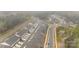 Aerial view of new community townhomes featuring attached garages along landscaped streets at 7918 Nelson Rd, Mint Hill, NC 92227