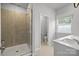 Bright bathroom featuring a walk-in shower and a window for natural light at 7918 Nelson Rd, Mint Hill, NC 92227