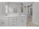 Bathroom with double sinks and vanity with white cabinets and framed mirror at 7918 Nelson Rd, Mint Hill, NC 92227