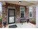 Cozy front porch with stone accents, bench seating, and a secure entrance at 7918 Nelson Rd, Mint Hill, NC 92227