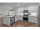 Contemporary kitchen showcasing white cabinetry, stainless appliances, and a functional layout at 7918 Nelson Rd, Mint Hill, NC 92227
