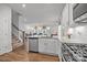 Well-lit kitchen with granite countertops, stainless steel appliances, and wood flooring at 7918 Nelson Rd, Mint Hill, NC 92227