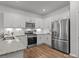 Well-equipped kitchen with white cabinets, stainless steel appliances, and modern finishes at 7918 Nelson Rd, Mint Hill, NC 92227