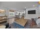 Open-concept living room with modern decor, wood floors, and seamless kitchen access at 7918 Nelson Rd, Mint Hill, NC 92227