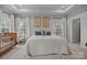 Bright main bedroom with large bed, neutral decor, and ample natural light at 7918 Nelson Rd, Mint Hill, NC 92227