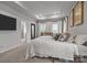 Cozy main bedroom with soft carpet, a large bed, and an attached bathroom at 7918 Nelson Rd, Mint Hill, NC 92227
