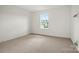 A bright, carpeted bedroom with a window that allows for natural light at 9516 Coast Laurel Nw Ave, Concord, NC 28027