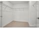 Walk-in closet featuring wire shelving and neutral carpeting at 9516 Coast Laurel Nw Ave, Concord, NC 28027