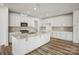 Stylish kitchen featuring bright white cabinets, stainless steel appliances, and a spacious center island at 9516 Coast Laurel Nw Ave, Concord, NC 28027