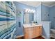Well-lit bathroom with a shower, vanity, and blue walls at 9709 Emerald Point Dr # 6, Charlotte, NC 28278