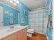Stylish bathroom with a wooden vanity, a striped shower curtain, and coordinated decor at 9709 Emerald Point Dr # 6, Charlotte, NC 28278