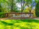 Landscaped Emerald Point community entrance sign with brick and stone accents under mature trees at 9709 Emerald Point Dr # 6, Charlotte, NC 28278