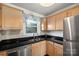 Bright kitchen with stainless steel appliances, sleek countertops, and undermount sink by window at 9709 Emerald Point Dr # 6, Charlotte, NC 28278