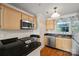 Modern kitchen with stainless steel appliances, granite countertops, and light wood cabinetry at 9709 Emerald Point Dr # 6, Charlotte, NC 28278