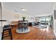 Open-concept living room with hardwood floors, stylish furnishings, and access to a private balcony at 9709 Emerald Point Dr # 6, Charlotte, NC 28278