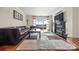 Spacious living room with a fireplace, large windows, and access to a balcony with scenic views at 9709 Emerald Point Dr # 6, Charlotte, NC 28278