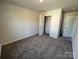 A carpeted bedroom with an open closet and neutral wall color at 1054 Horizon Ln, Chester, SC 29706