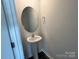 Stylish half bath with a pedestal sink and modern mirror at 1054 Horizon Ln, Chester, SC 29706