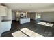 Open living and kitchen area with modern appliances, an island, and wood floors at 1054 Horizon Ln, Chester, SC 29706