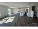 Bright living room with wood floors, kitchen access, and sliding glass doors at 1054 Horizon Ln, Chester, SC 29706