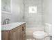 A newly renovated bathroom featuring modern fixtures, a stylish vanity, and a tiled shower at 108 Graham St, Chester, SC 29706