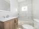 Bright bathroom featuring white tile, a new vanity, contemporary fixtures, and a tiled tub and shower combo at 108 Graham St, Chester, SC 29706